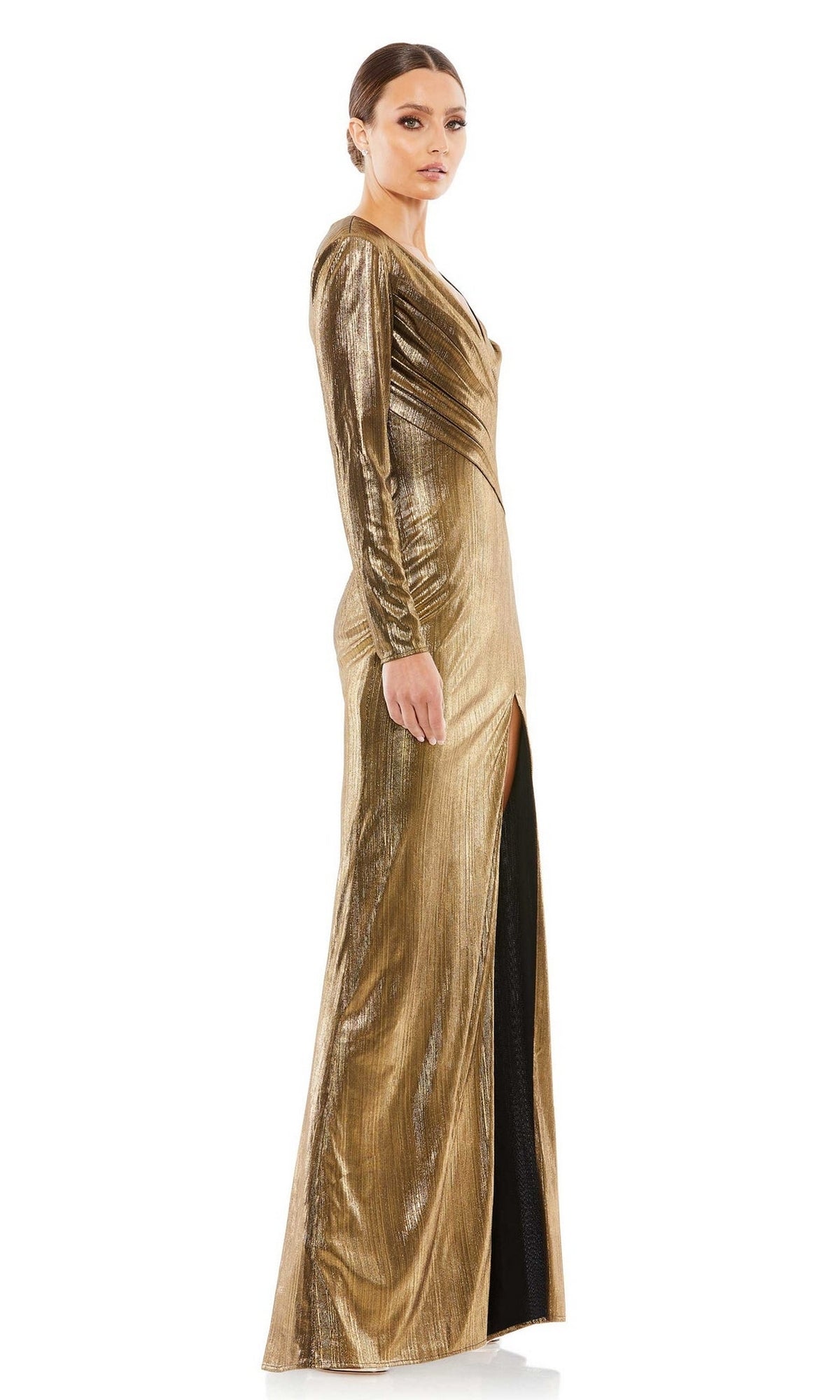 A woman poses in profile against a white background, wearing the Mac Duggal 26684 Long Sleeve Gold Formal Gown with a high slit and her hair tied back.